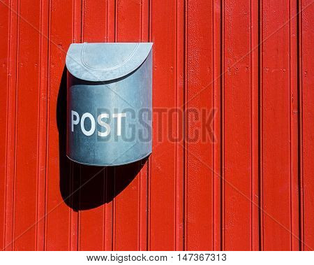 Red wood wall vounted silver post box