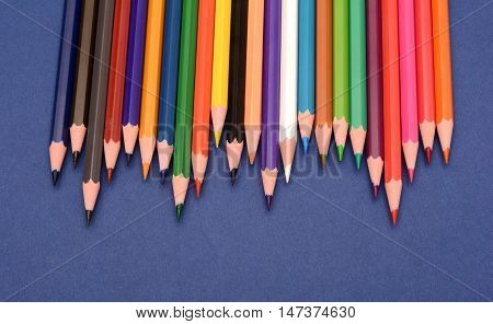 Set of Colorful pencils isolated on blue background.