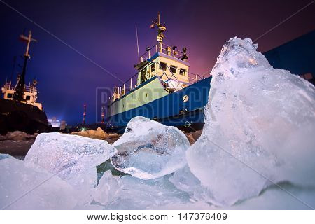 The Icebreaker Ship Trapped In Ice Tries To Break And Leave The Bay Between The Glaciers