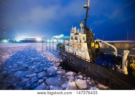 The Icebreaker Ship Trapped In Ice Tries To Break And Leave The Bay Between The Glaciers