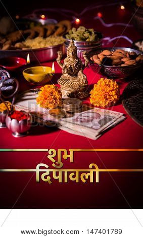 Happy Diwali Greeting card showing oil lamp or diya with crackers, sweet or mithai, dry fruits, indian currency notes, marigold flower and statue of Goddess Laxmi or Lakshmi on diwali night