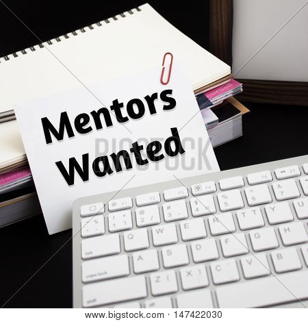 Word text Mentors wanted on white paper card / business concept