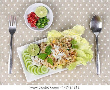 Fried rice with crab served  spicy side dish on brown. Top view