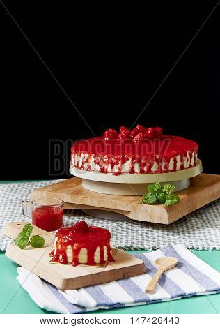 Crepe cake with strawberry sauce on table