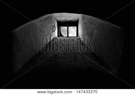 Full moon seen through the window from dark basement or prison