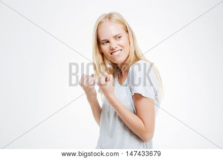 Portrait of a excited young woman celebrating her success isolated on a white background