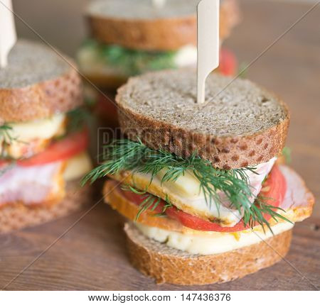sandwiches with cheese carbonade tomato on a wooden table