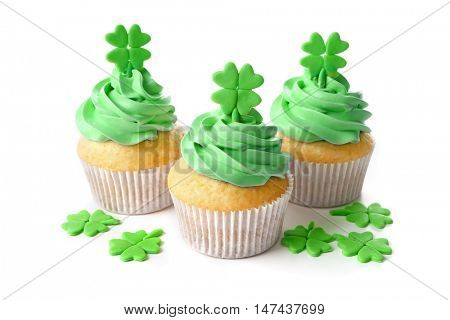 Tasty cupcakes with clover, isolated on white. Saint Patrics Day concept