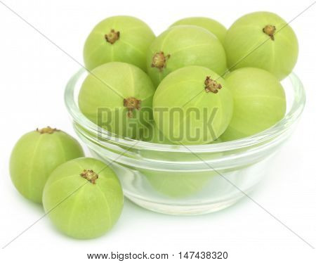 Amla fruits in a glass bowl over white background