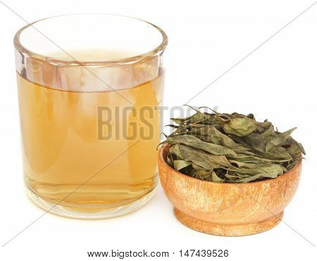 Ayurvedic medicinal Chirata with herbal juice in a glass