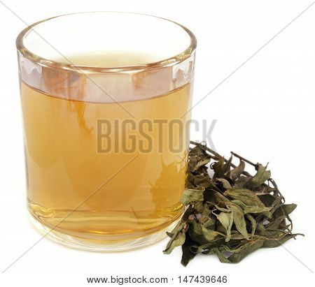 Ayurvedic medicinal Chirata with herbal juice in a glass
