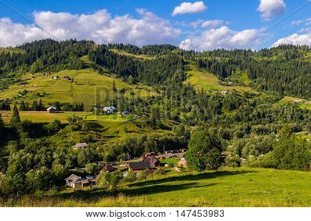 Rural houses in village Dzembronia at Carpathian mountains nature summer landscape Ukraine