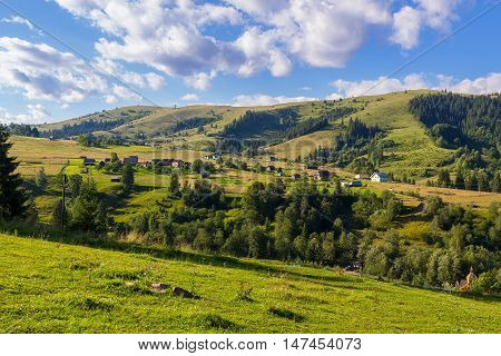 Rural houses in village Dzembronia at Carpathian mountains nature summer landscape Ukraine
