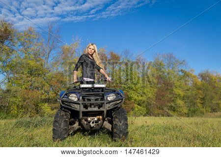 Elegant Blonde Woman Riding Extreme Quadrocycle Atv On Summer Field