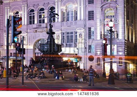 United Kingdom England London - 2016 June 17: Popular tourist Picadilly circus with flags union jack in night lights illumination