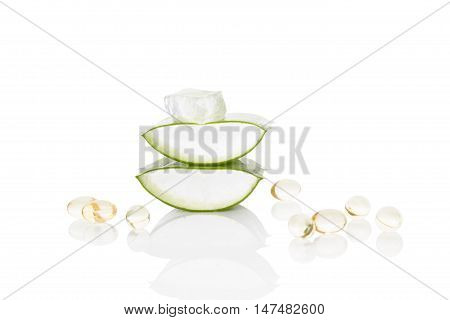 Aloe vera gel caps. Aloe vera sliced leaf and aloe vera gel caps isolated on white background.