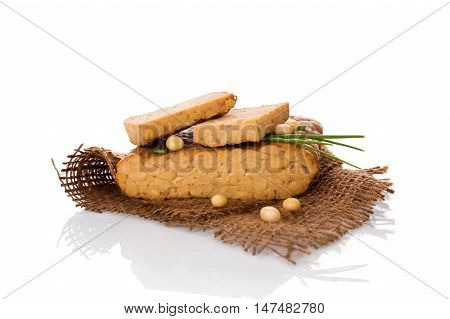 Tempeh isolated on white. Traditional soybean product.