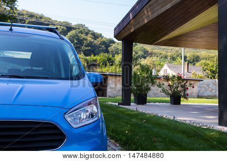 blue car parking on the house terrace