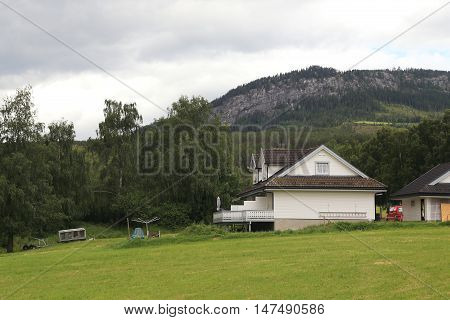 TORPO, NORWAY - JULY 2, 2016: There are modern houses and homestead land in the highland countryside.