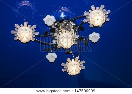 Chrystal chandelier close-up. blue light. Selective focus