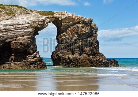 Natural Arch On Beach.