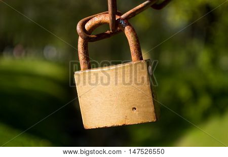 Rusty lock on the bridge in the park