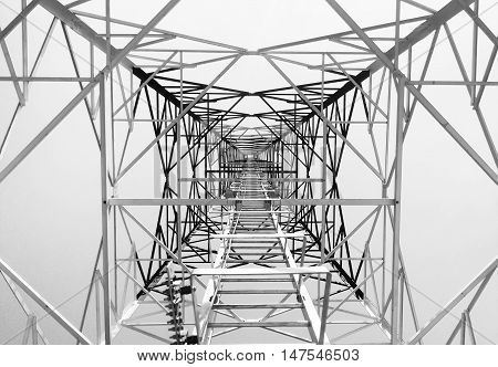 Newly completed telecommunication tower with white and red paint step ladder in black and white format