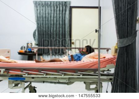 blurry of little boy sick in the Hospital with saline intravenous (iv) use inhaler mask for kid the hopital