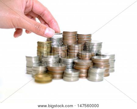 Saving money concept. Woman hand put coins to stack of coins. Savings Finance Business Investment Growth Concept. (selective focus)