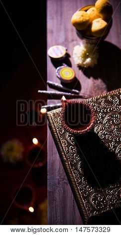 beautiful diwali diya with fire crackers and sweet pera, selective focus