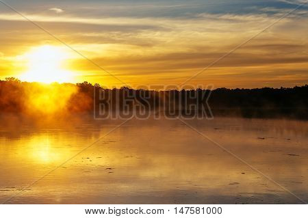 Autumn fog in the morning on the river fog lake sunrise
