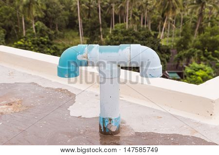 Old PVC air vent pipes on roof top of building