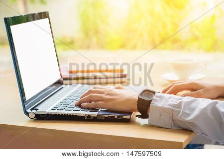 Hand using laptop in Morning business concept