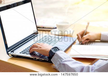 Hand using laptop in Morning business concept