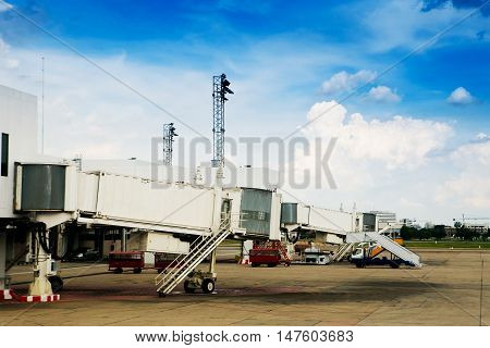 Empty jetway with airplane at the airport on loading on background