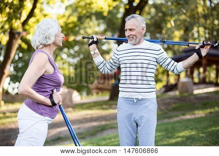 Whole life together. Likable aged couple looking happy together while working-out