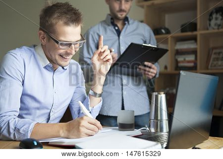 Two businessmen at work have a good idea