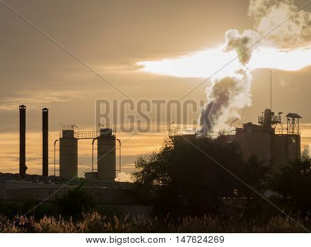 The refinery industry: this is oil refinery industry in Southeast Asia. In the picture a meadow Refinery and the glare of the sun on the left side of the image.