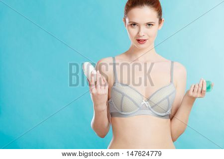 Girl Applying Stick Deodorant In Armpit