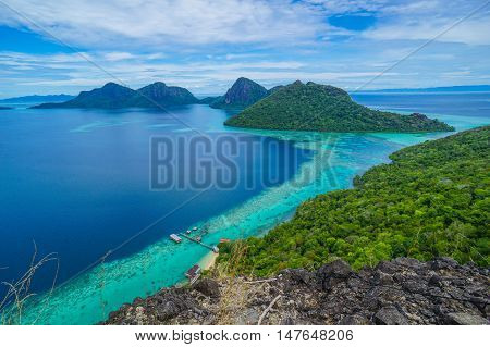 National Park on top of Bohey Dulang island near Sipadan Island,Sabah,Borneo.Mirror smooth ocean surrounded by mountains.The bright blue water and rocky shore in the tropical island of Semporna,Borneo
