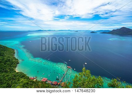 National Park on top of Bohey Dulang island near Sipadan Island,Sabah,Borneo.Mirror smooth ocean surrounded by mountains.The bright blue water and rocky shore in the tropical island of Semporna,Borneo