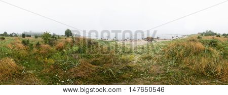 Rocky beach and morning fog in summer. Sea mist coast forest seaside natural environment. Shore in Koipsi Island Estonia Europe. 360 degrees panorama.