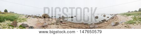 Rocky beach and morning fog in summer. Sea mist coast forest seaside natural environment. Shore in Koipsi Island Estonia Europe. 360 degrees panorama.