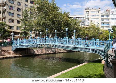 ESKISEHIR TURKEY - SEPTEMBER 03 2016: People passing over the bridge on Porsuk River. Porsuk river is one of the most populer touristy place with boat tours and entertainment in Eskisehir.