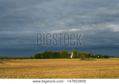 Mary's Church grain field blue sky and natural environment. Torma in the summer small village in Estonia. Europe