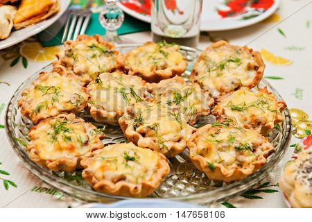Tartlets With Cheese And Mushrooms On A Festive Table