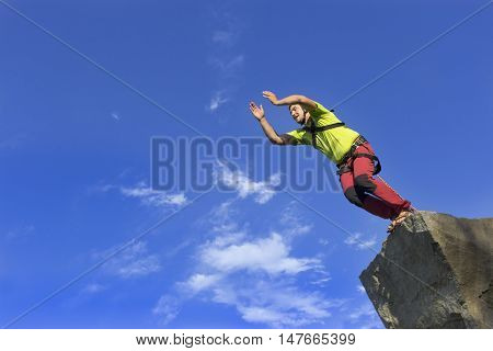 The first jump off the cliff with a safety rope.