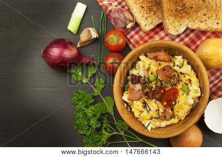 Scrambled eggs with fried bacon. English breakfast. Toast and scrambled eggs with chives. Recipe for a healthy meal.