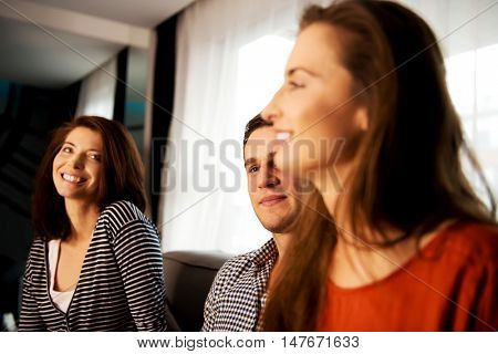 Sisters and brother relaxing at home.