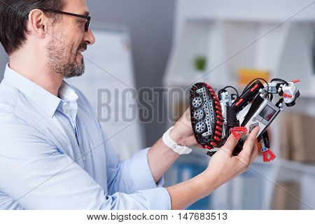 Suprise. Attractive old man getting a robot for a gift